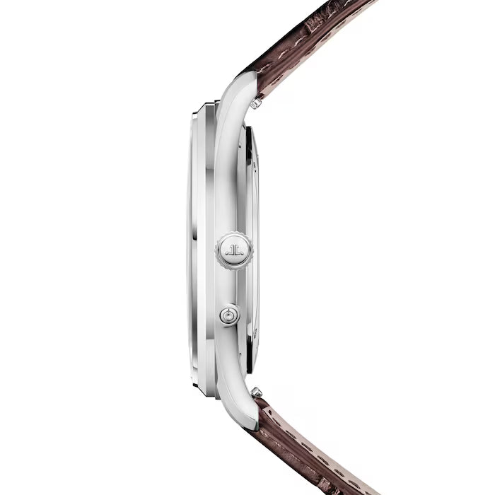 A side view of the Jaeger-LeCoultre Master Ultra Thin Moon showcases its slender silver case and logo-engraved crown, while the moon phase watch exudes elegance with a refined brown leather strap.