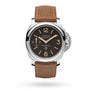 The Panerai Luminor Marina es men's luxury watch features a brown leather strap, stainless steel case, black dial with beige numerals, small seconds sub-dial, bold crown protector, and a precise mechanical movement.