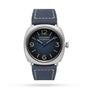 The Panerai Radiomir Origine is a luxury watch featuring a square stainless steel case, blue leather strap, dark blue dial with gold Arabic numerals, and distinctive Radiomir Panerai branding.