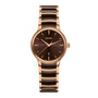 The Rado Centrix is a luxury gold and brown watch with a round face, minimalist hour markers, a date window at 6 o’clock, and a sleek metal link band.