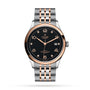 The TUDOR 1926 features a black textured dial, rose gold accents, a date window at 3 o’clock, and a two-tone stainless steel and rose gold bracelet—perfect for those seeking classic elegance.