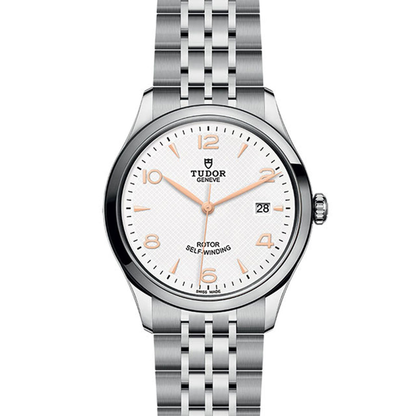 The TUDOR 1926 is a stainless steel wristwatch with a white dial, gold hour markers, date display at 3 oclock, and a silver link bracelet.