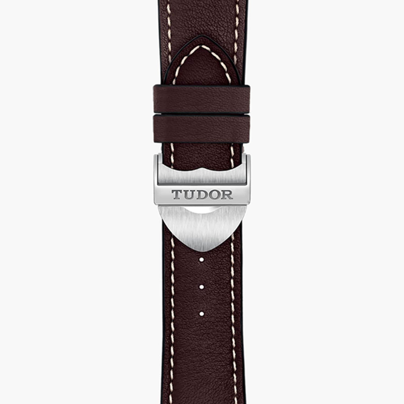 Close-up of a brown leather TUDOR 1926 watch strap featuring white stitching and a silver clasp engraved with the TUDOR logo.