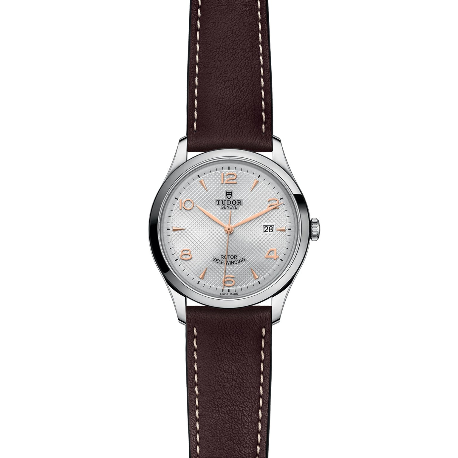 The TUDOR 1926 is a silver wristwatch featuring a white dial, gold hour markers, date at 3 oclock, and a brown leather strap—reflecting traditional mechanical watchmaking from the founder of Rolex.