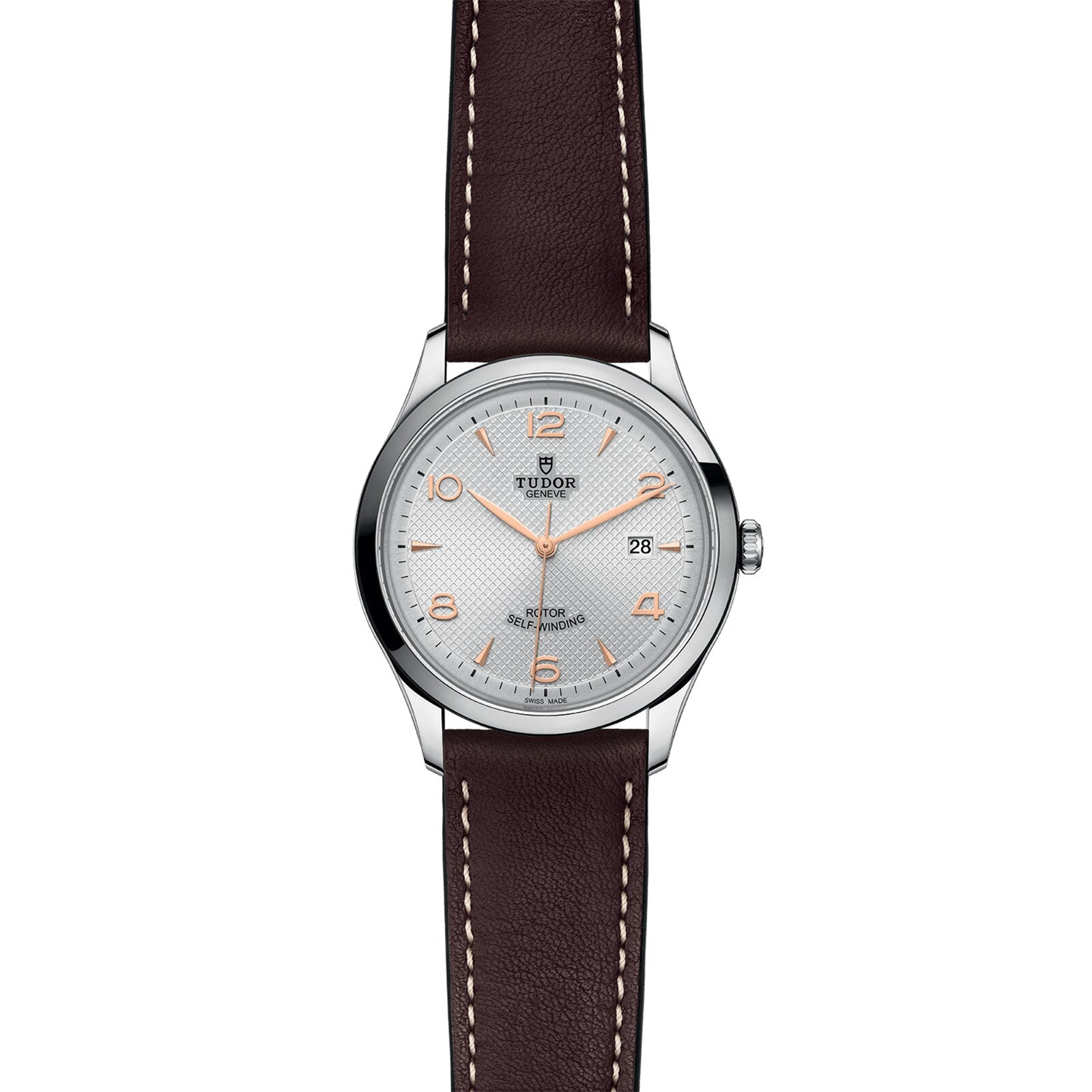 The TUDOR 1926 is a silver wristwatch featuring a white dial, gold hour markers, date at 3 oclock, and a brown leather strap—reflecting traditional mechanical watchmaking from the founder of Rolex.