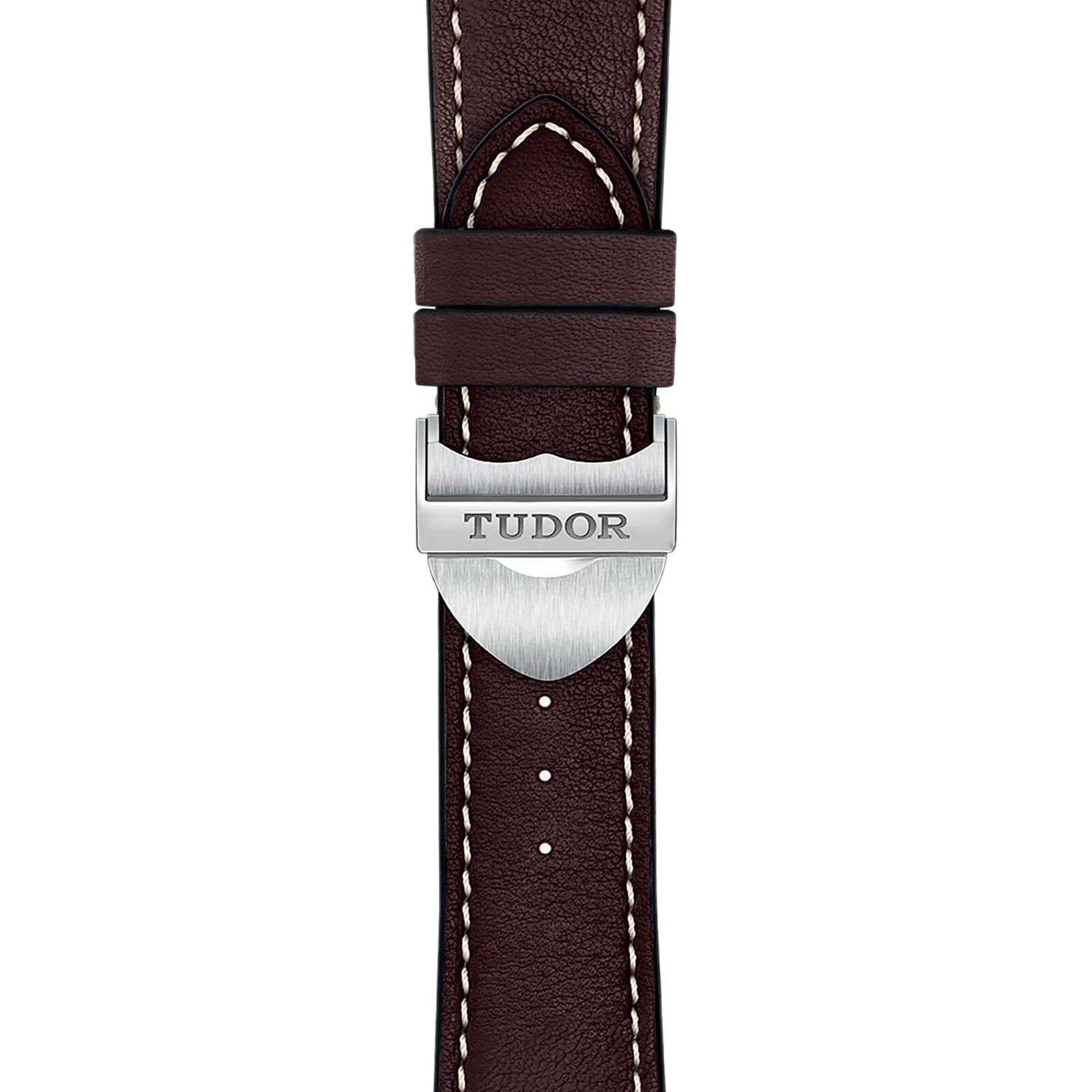 Close-up of a brown leather strap with white stitching and a silver clasp engraved with TUDOR, exemplifying the refined craftsmanship of the TUDOR 1926 collection.