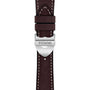 Close-up of a classic brown leather TUDOR 1926 watch strap, featuring white stitching and a silver clasp engraved with the Tudor logo.