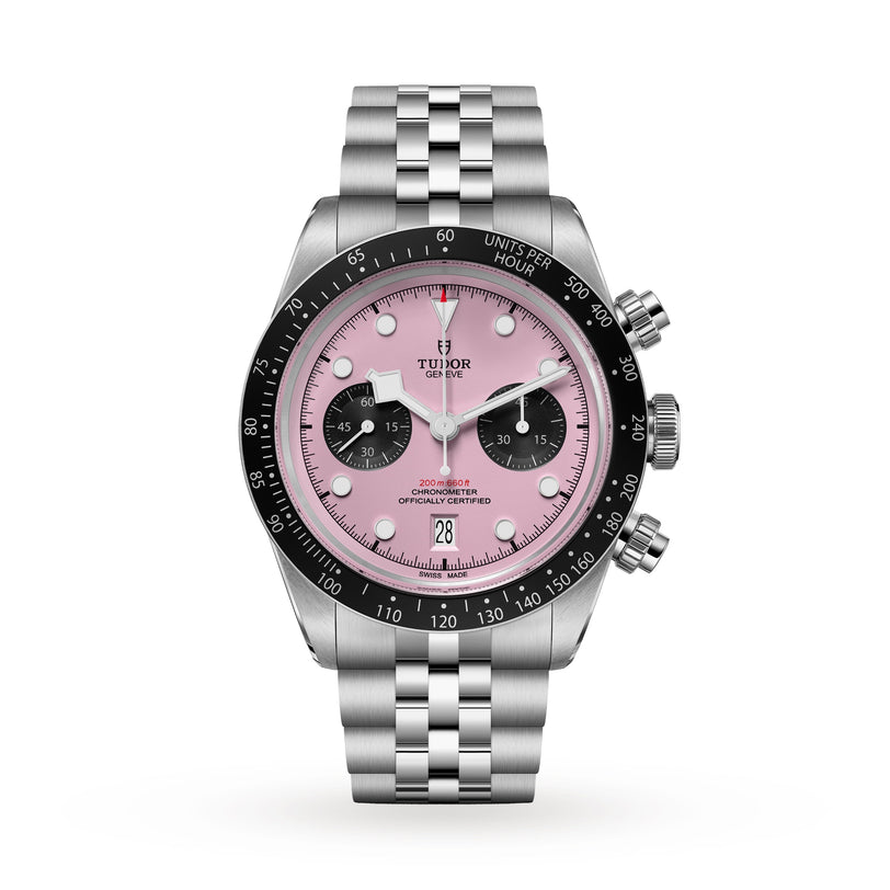 The TUDOR Black Bay Chrono features a pink dial with black subdials, a black bezel, a silver jubilee-style bracelet, chronometer certification, and a date display at 6 o’clock.