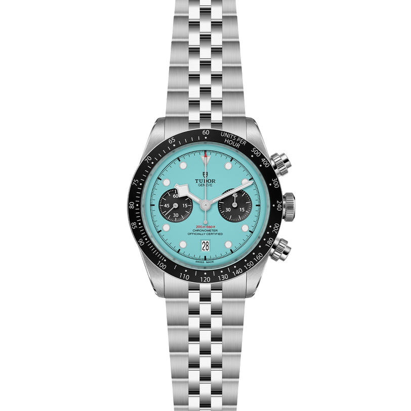 The TUDOR Black Bay Chrono is a stainless steel wristwatch with a turquoise dial, black bezel, three subdials, date window, and silver metal bracelet, powered by a precise Swiss Chronometer Manufacture Calibre.