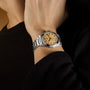 TUDOR Monarch watch with cream dial and stainless steel bracelet worn on wrist.
