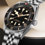 Tudor stainless steel watch with black dial, gold hour markers, rotating bezel, and matching metal bracelet.