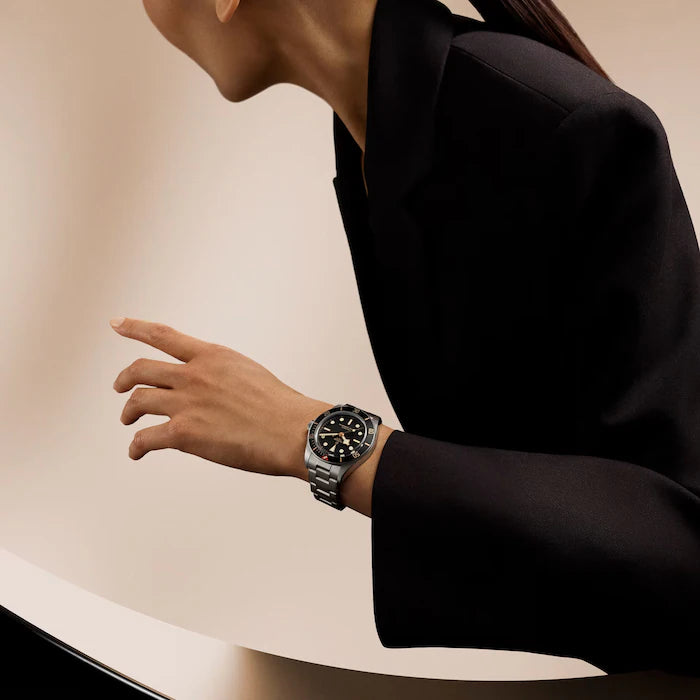 Black Bay 58 watch with black dial and stainless steel bracelet worn on wrist.