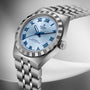 TUDOR Royal stainless steel watch with light blue dial, blue Roman numerals, and matching steel bracelet.