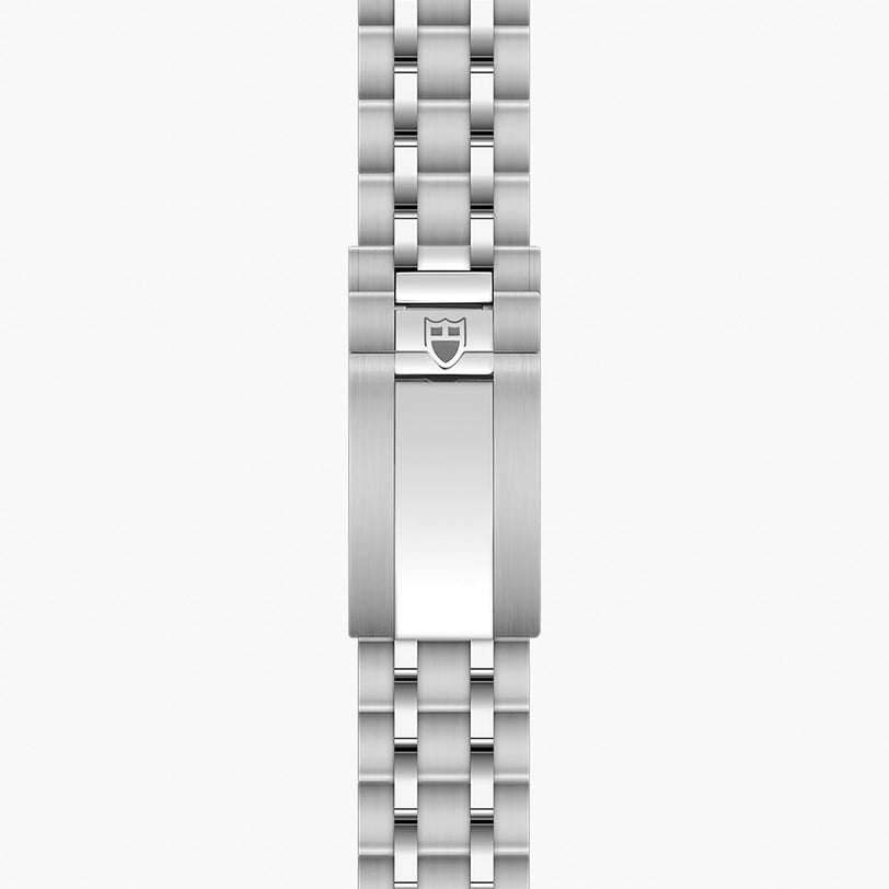 Stainless steel watch bracelet with linked metal bands and shield emblem clasp.
