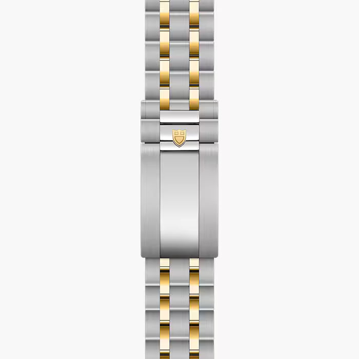 Two-tone stainless steel and gold bracelet with Tudor shield logo clasp, laid flat.