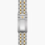 Two-tone stainless steel and gold bracelet with Tudor shield logo clasp, laid flat.