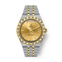 Two-tone steel and gold watch with champagne dial, day-date window, and textured bezel.