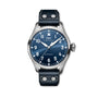The IWC Schaffhausen Big Pilots Watch 43 showcases a bold blue dial, white numerals, and a black leather strap with white stitching, elegantly set against a white background.
