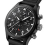 Black chronograph watch with dark dial, multiple subdials, white numerals and hands, red accent, and black rubber strap.