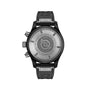 Black pilot chronograph watch with round case, gray rubber strap, and engraved caseback visible from behind.