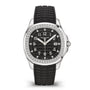 The Patek Philippe Aquanaut 5267/200A-001 is a luxury watch featuring a black dial, diamond bezel, black rubber strap, and silver hour markers.
