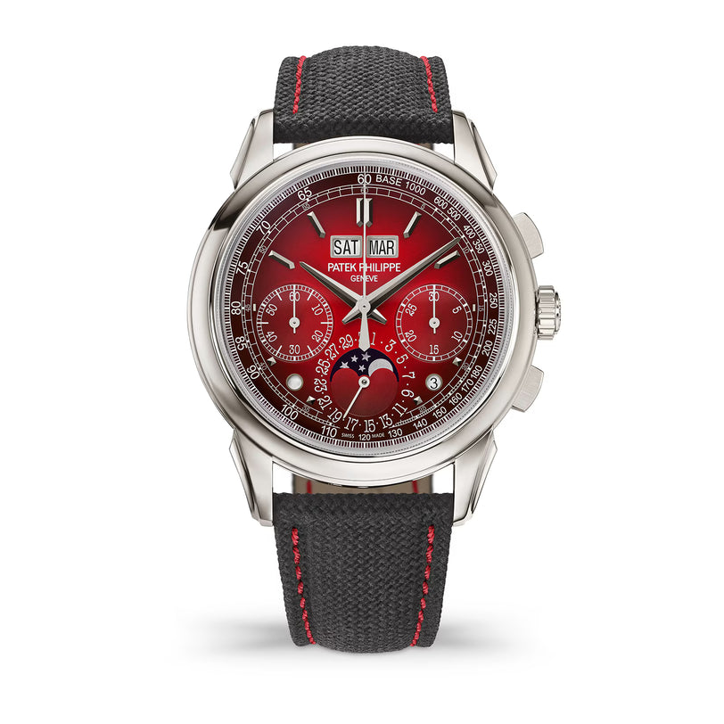 Luxury watch with red face and black strap on white background