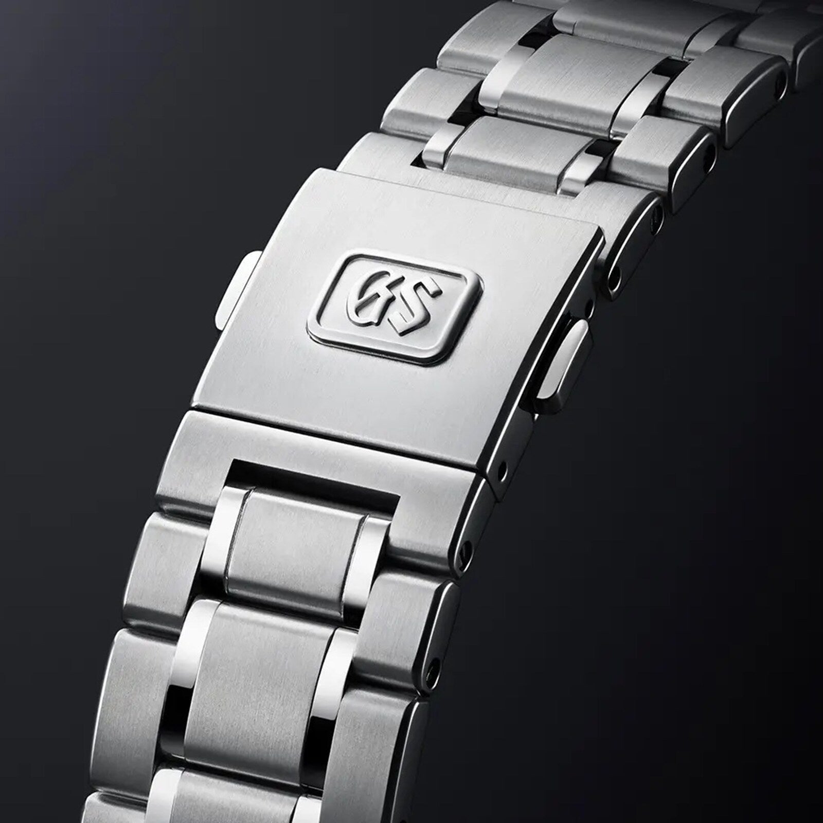 Close-up of the Hi-Beat Heritage stainless steel bracelet with clasp, featuring the Grand Seiko logo engraved—showcasing precision and craftsmanship, handmade in Japan.