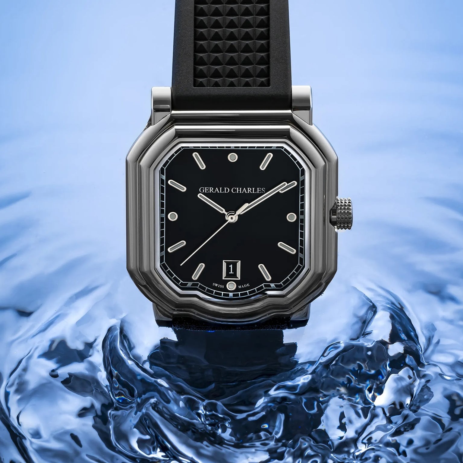The Gerald Charles Maestro 2.0 Ultra-Thin watch, featuring a black strap and dial, is elegantly displayed against a rippling blue water background.