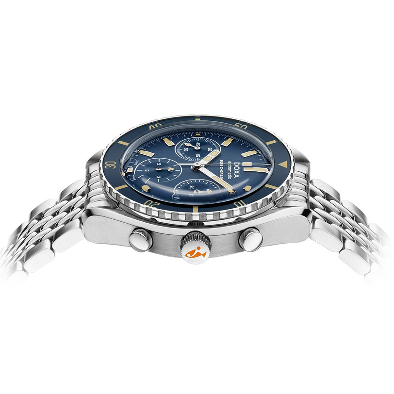 The DOXA Sub 200 C-Graph Caribbean is a stainless steel chronograph wristwatch with a blue dial, two subdials, a silver bracelet, and Swiss movement, shown from the side.