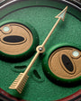 Close-up of a watch face with green and brown design