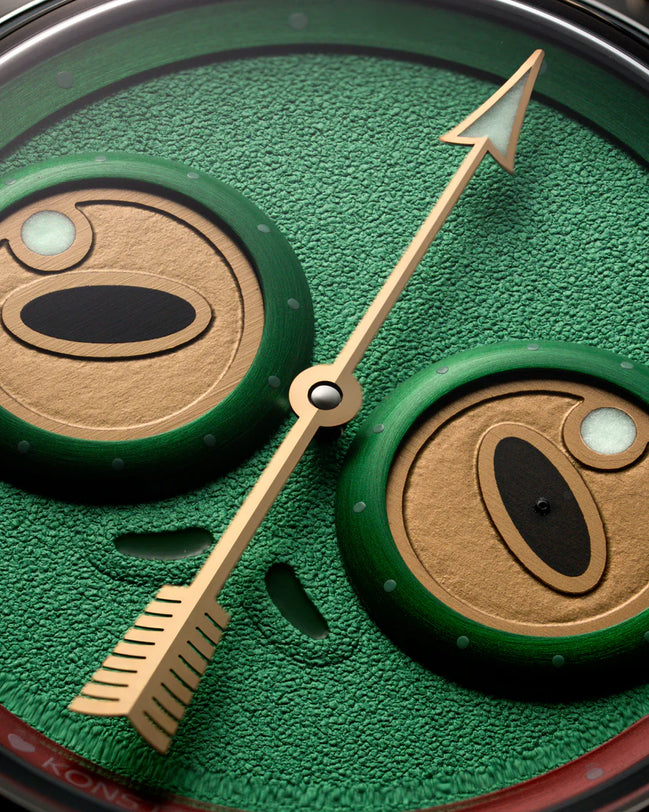 Close-up of a watch face with green and brown design