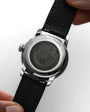 Close-up of a Louis Erard watch with a black leather strap on a white background