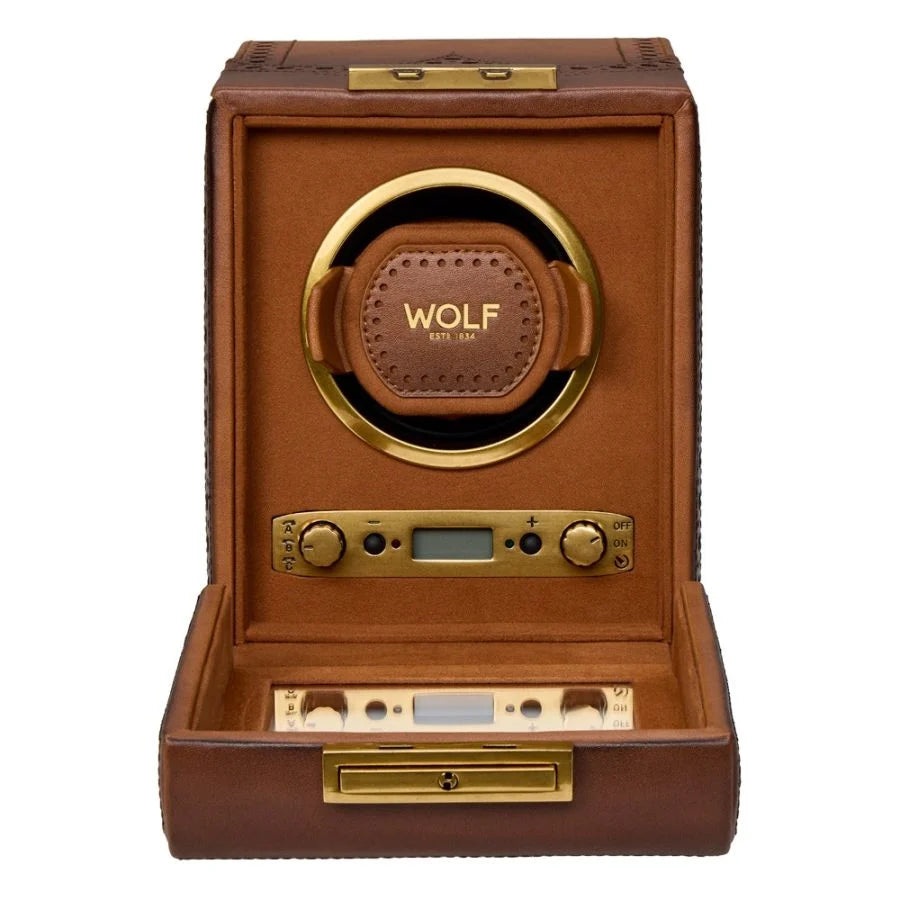 Brown leather watch winder with gold-tone hardware, circular brown leather watch cushion, digital display, and control button