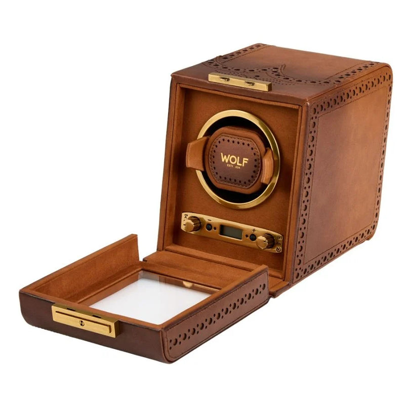 Brown leather watch winder with perforated detailing, gold-tone accents, rotating watch head, and open storage drawer.