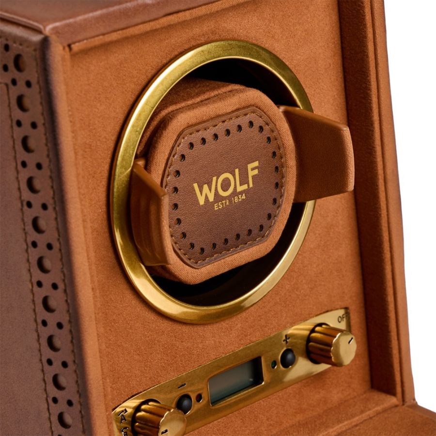Brown leather watch winder with brass trim, circular watch holder, and control panel with dial and digital display.