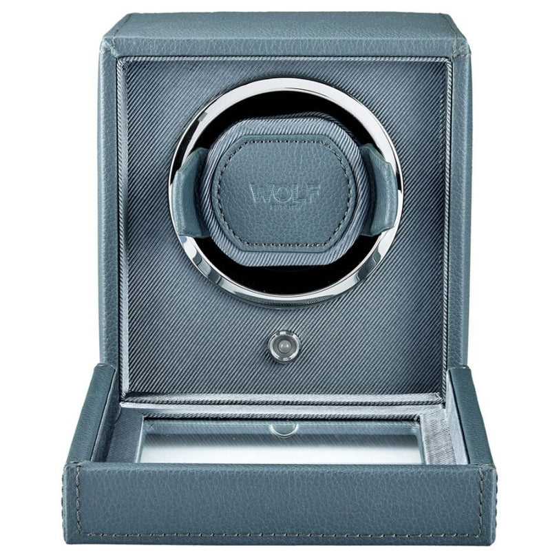 Blue-gray leather watch winder with single rotating cup, chrome accents, and hinged cover.