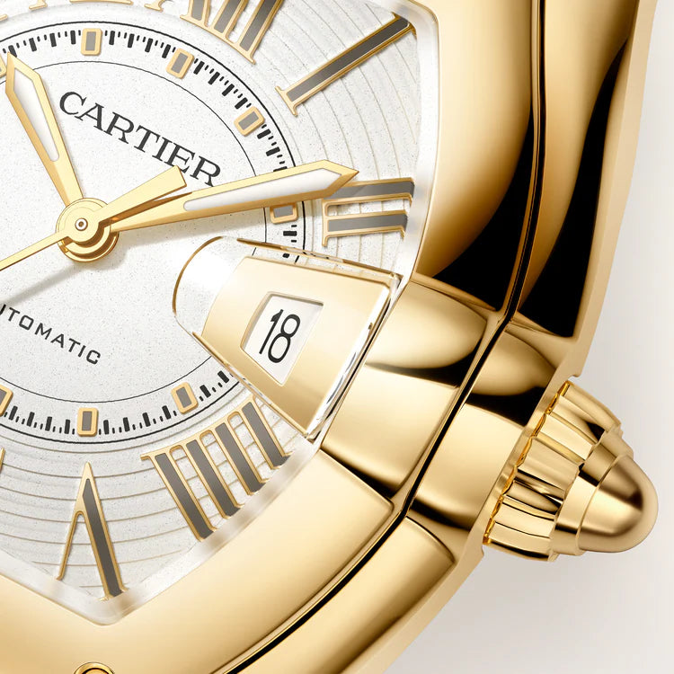Cartier Roadster watch with white dial, gold-tone hands, date window displaying 18, and matching gold-tone bracelet.
