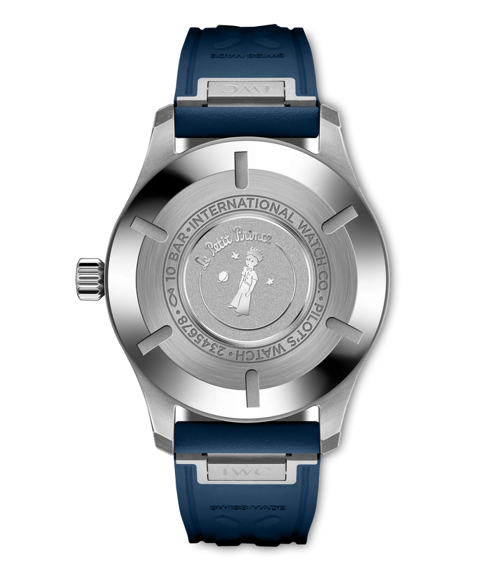 Stainless steel pilot's watch with white dial, blue rubber strap, and engraved caseback featuring Le Petit Prince illustratio