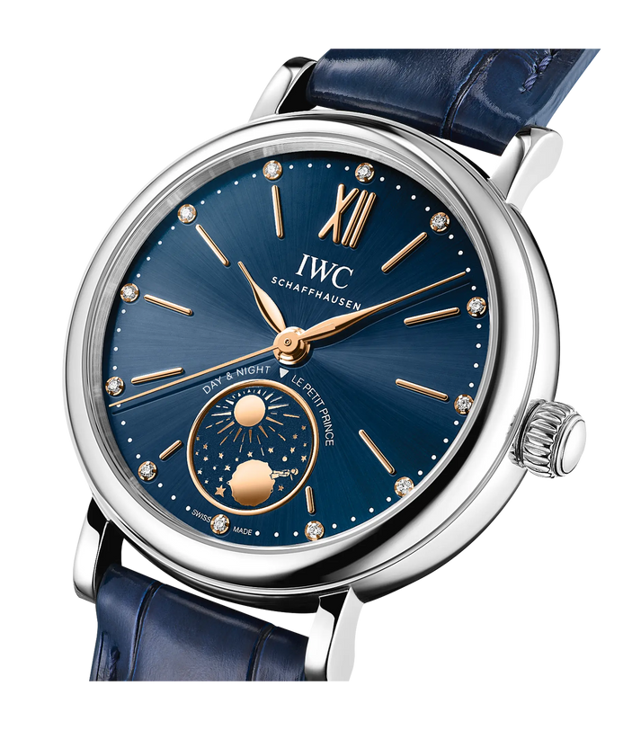 Silver-cased watch with blue dial, rose gold hands and hour markers, diamond indices, day-night subdial, and blue leather str