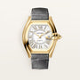 Cartier Roadster watch with gold-toned case, white dial, Roman numerals, date window, and gray leather strap.