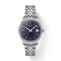 Silver Tissot watch with blue dial on a white background