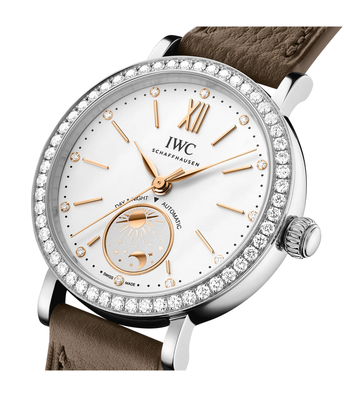 Silver stainless steel watch with white dial, rose gold hands and hour markers, diamond bezel, day-night indicator, and taupe