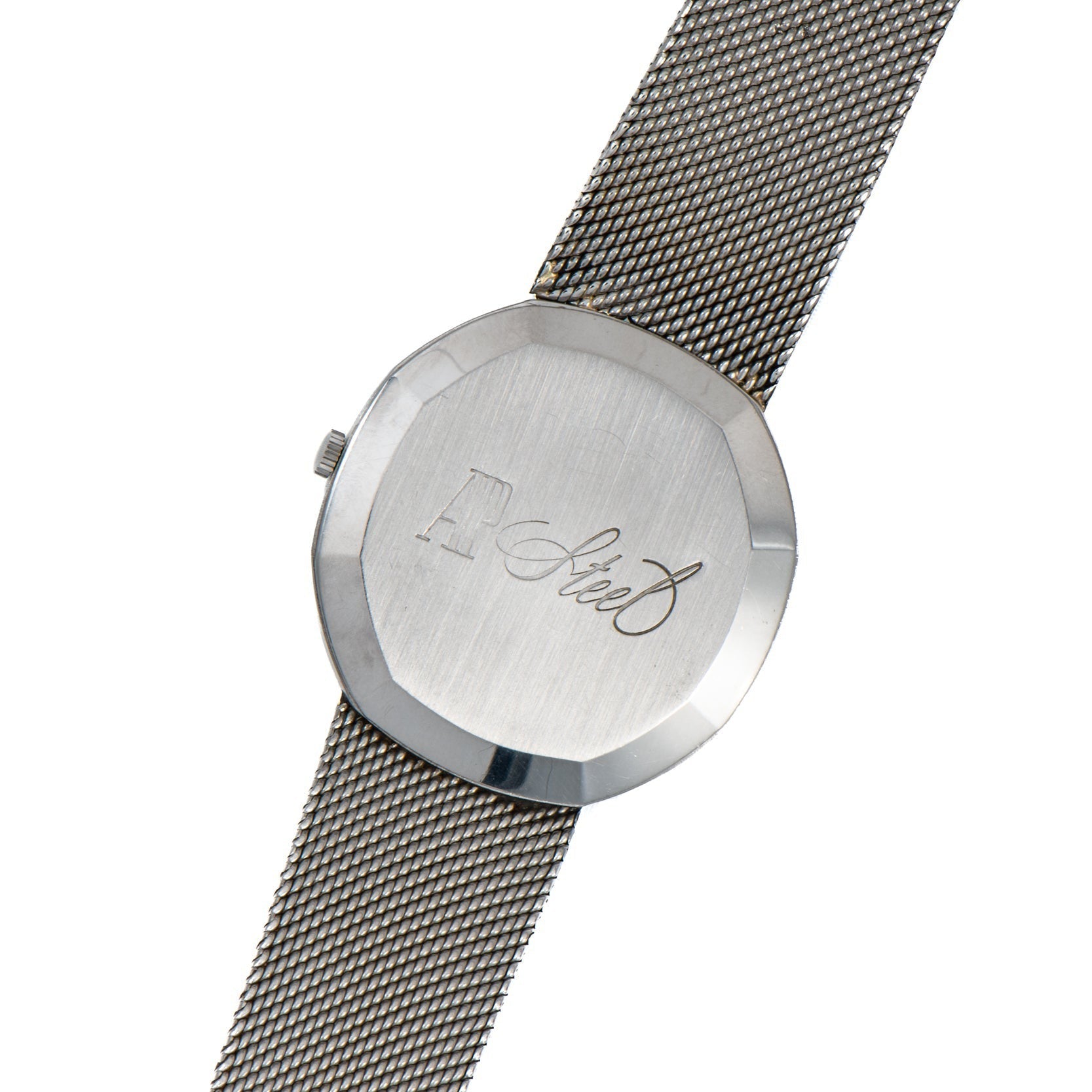 Audemars Piguet Steel Dress Watch featuring a mesh band and cursive engraving on the back, shown from above.