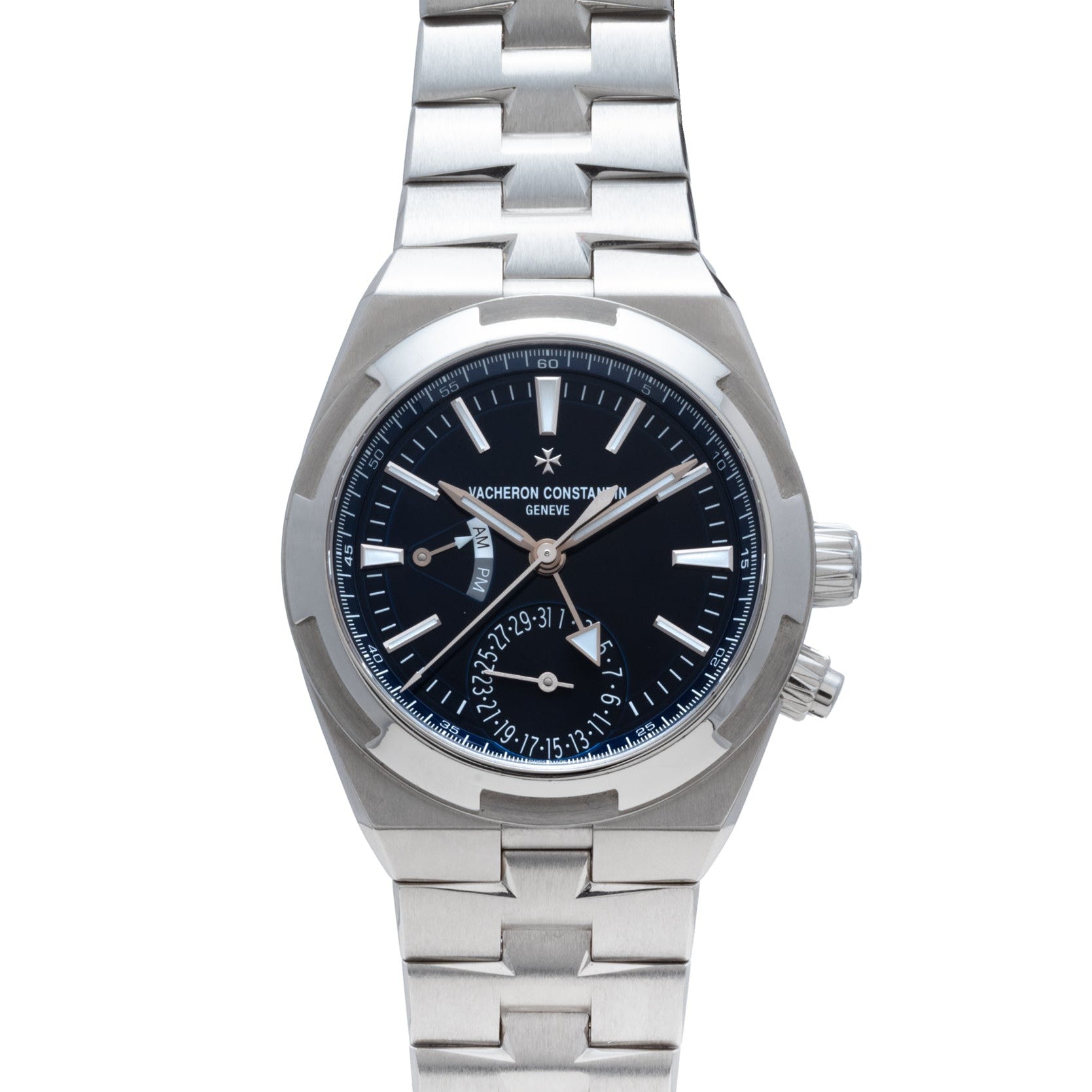 The Vacheron Constantin Overseas Dual-Time features a silver case, black dial, metal bracelet, and angled date display.