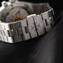Close-up of the Vacheron Constantin Overseas Dual-Time stainless steel bracelet featuring a Maltese cross engraved on the clasp.