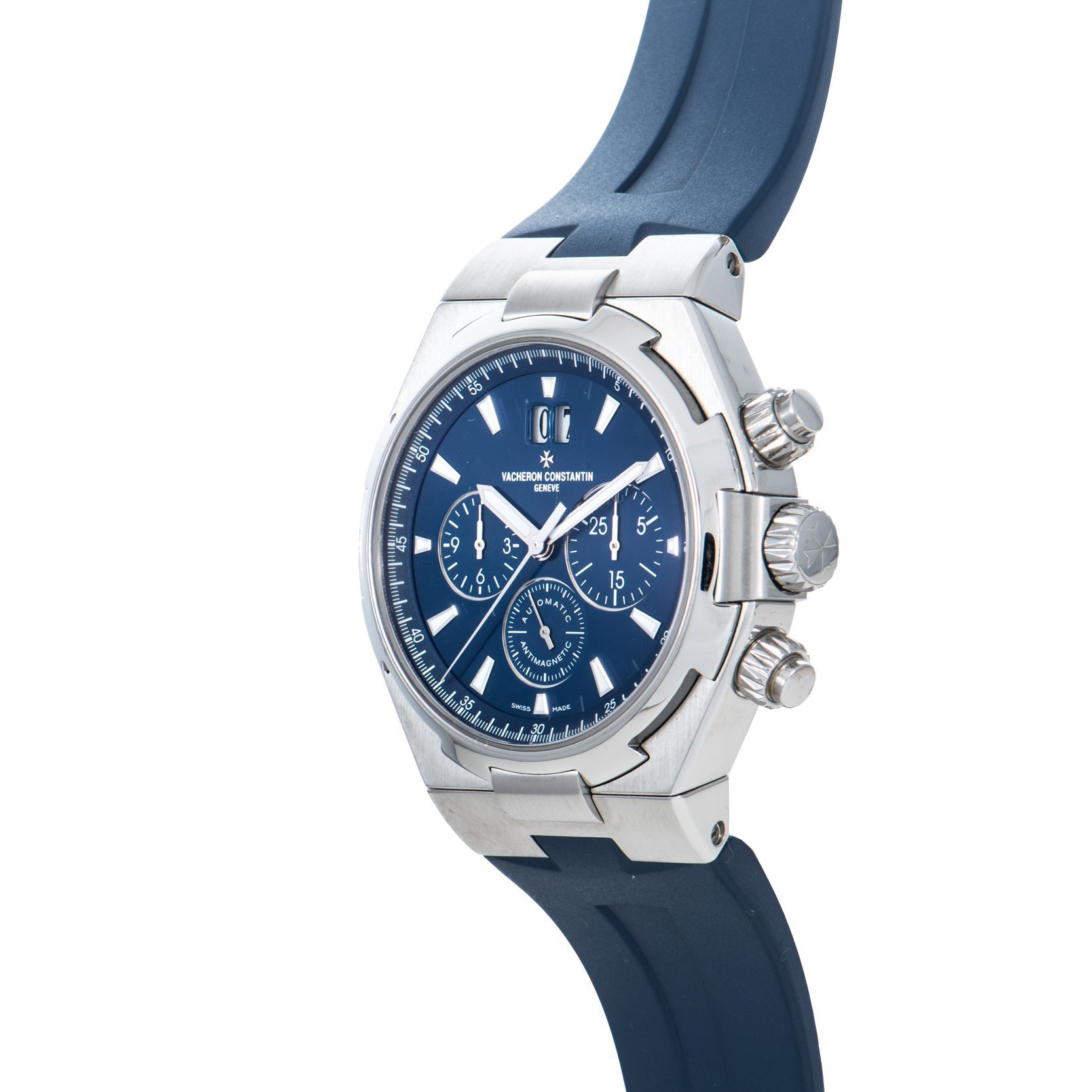 The Vacheron Constantin Overseas Chronograph features a silver and blue dial with a blue rubber strap, shown at an angle against a white background.