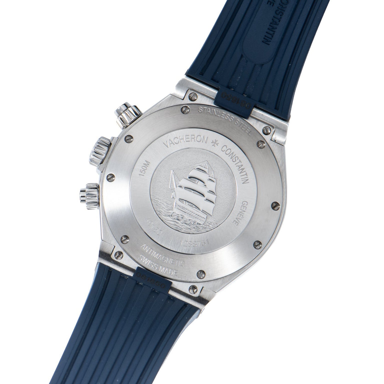 The back of a Vacheron Constantin Overseas Chronograph watch features a blue strap, an engraved ship, and visible inscriptions on the case.