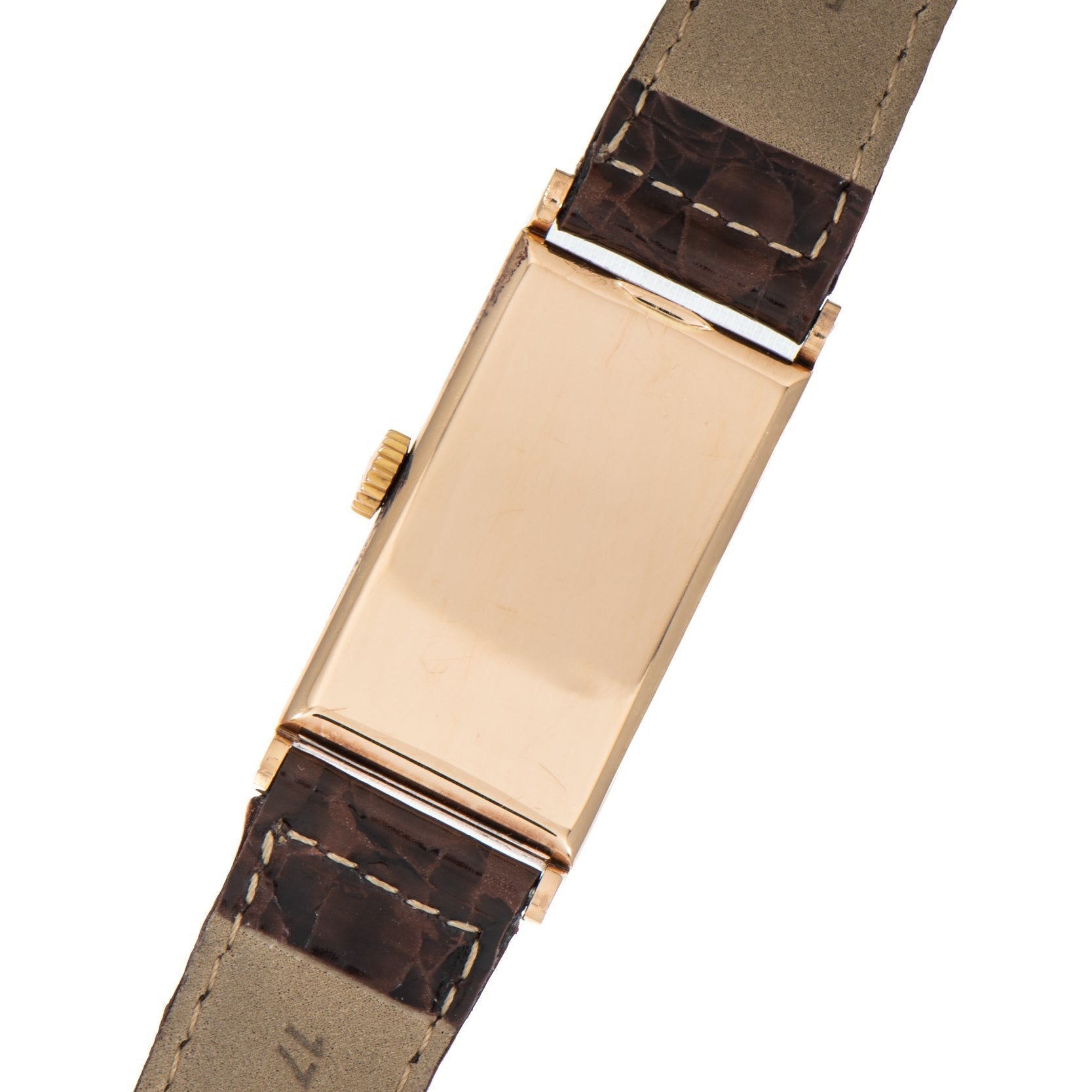 The Patek Philippe Tegolino Dress Watch is a gold rectangular wristwatch with a leather strap, shown from the back with no visible markings or face.