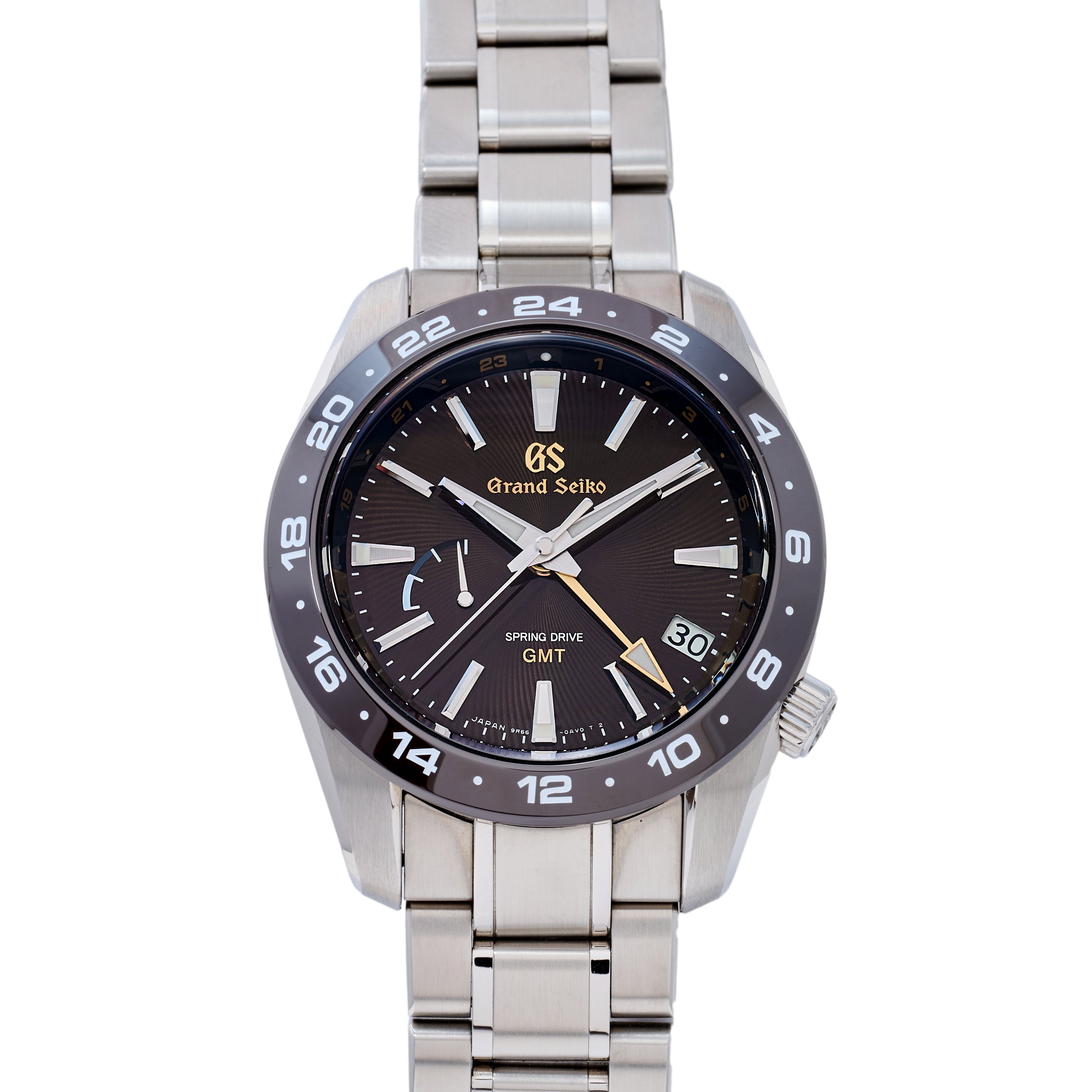Grand Seiko watch with black dial and silver metal strap on a white background