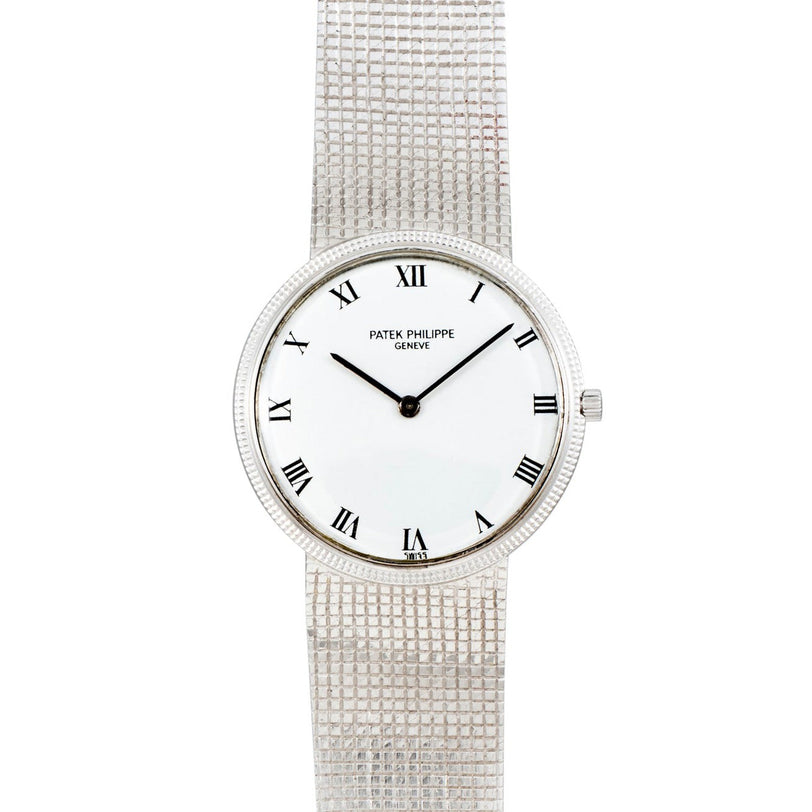 A silver Patek Philippe Calatrava wristwatch featuring a white face with black Roman numerals.